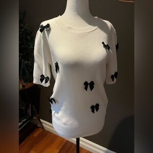 White Sweater with Black Bow Accents